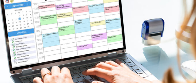 woman editing her calendar with color coded time blocks