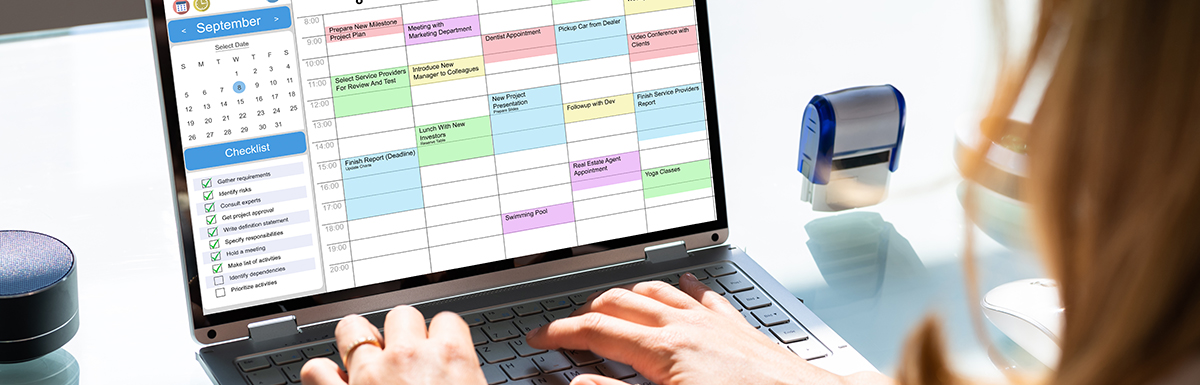 woman editing her calendar with color coded time blocks